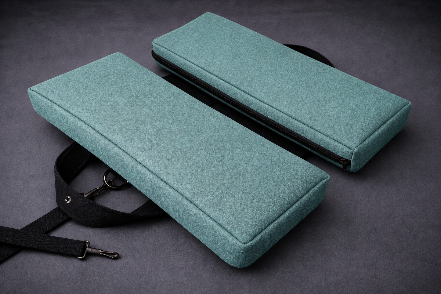Bermuda green foldable travel seat cushion with slim white zipper and black adjustable strap, designed for pelvic and tailbone pressure relief