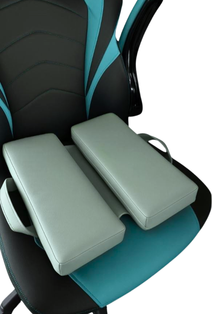 Sage green faux leather ergonomic seat cushion with handles, designed for comfort and support, displayed on a modern black and turquoise gaming chair. Ideal for home office, gaming, or long sitting sessions.