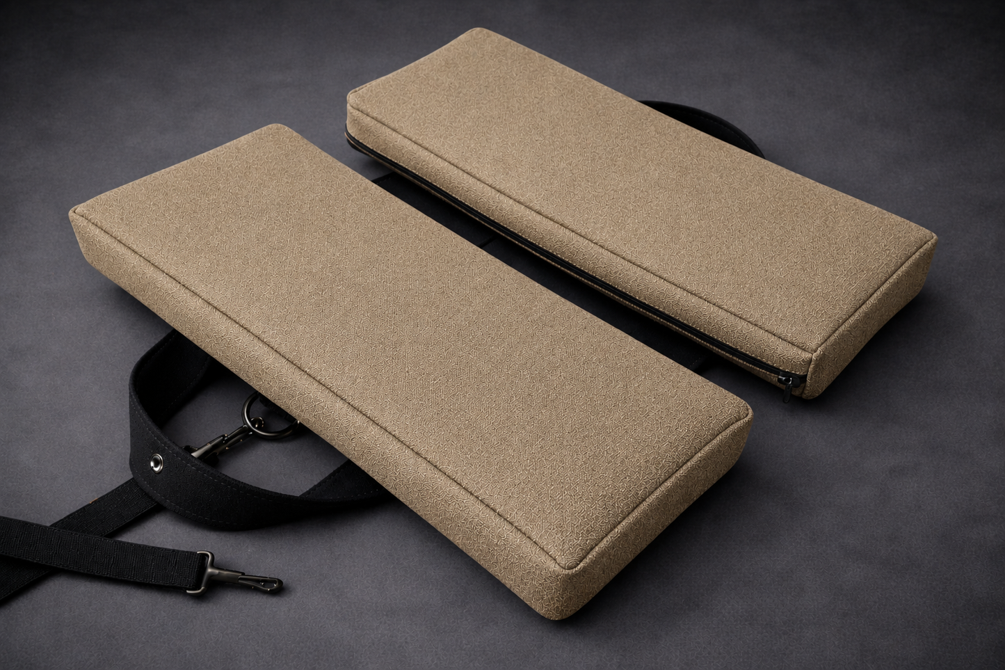 SunCloud® beige foldable travel seat cushion with black adjustable shoulder strap, removable zippered cover, and ergonomic pressure relief design on a dark gray background