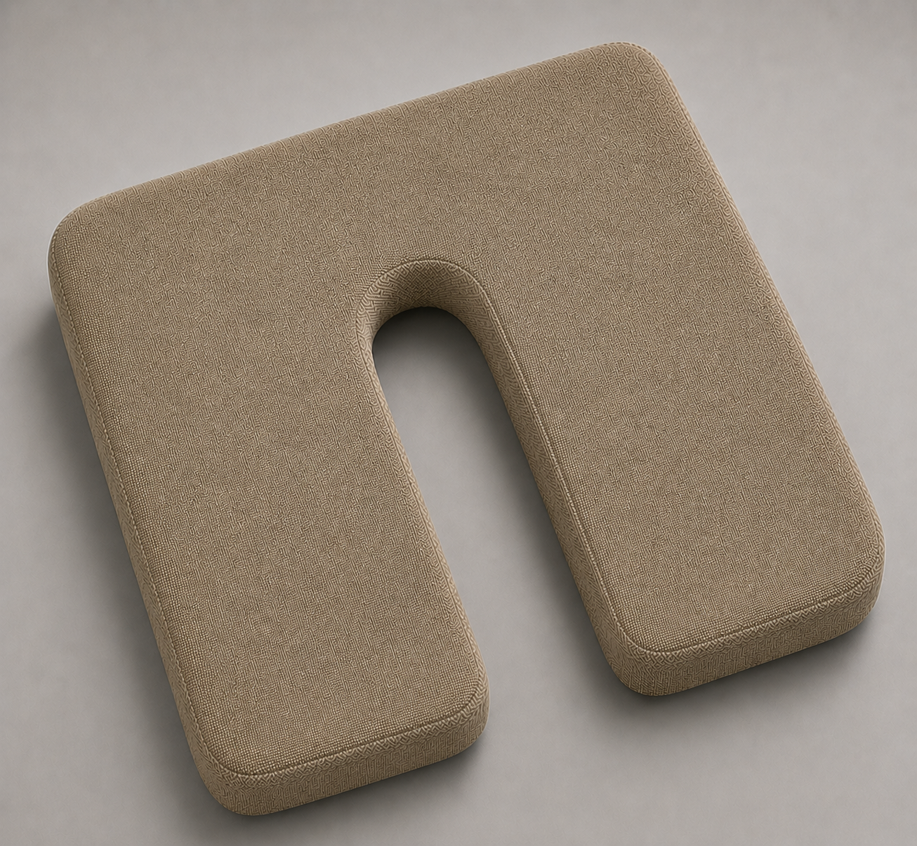 SunCloud® beige U-shaped coccyx seat cushion with centered black metal D-rings, smooth linen-style fabric, and tailbone relief cutout on a soft gray background