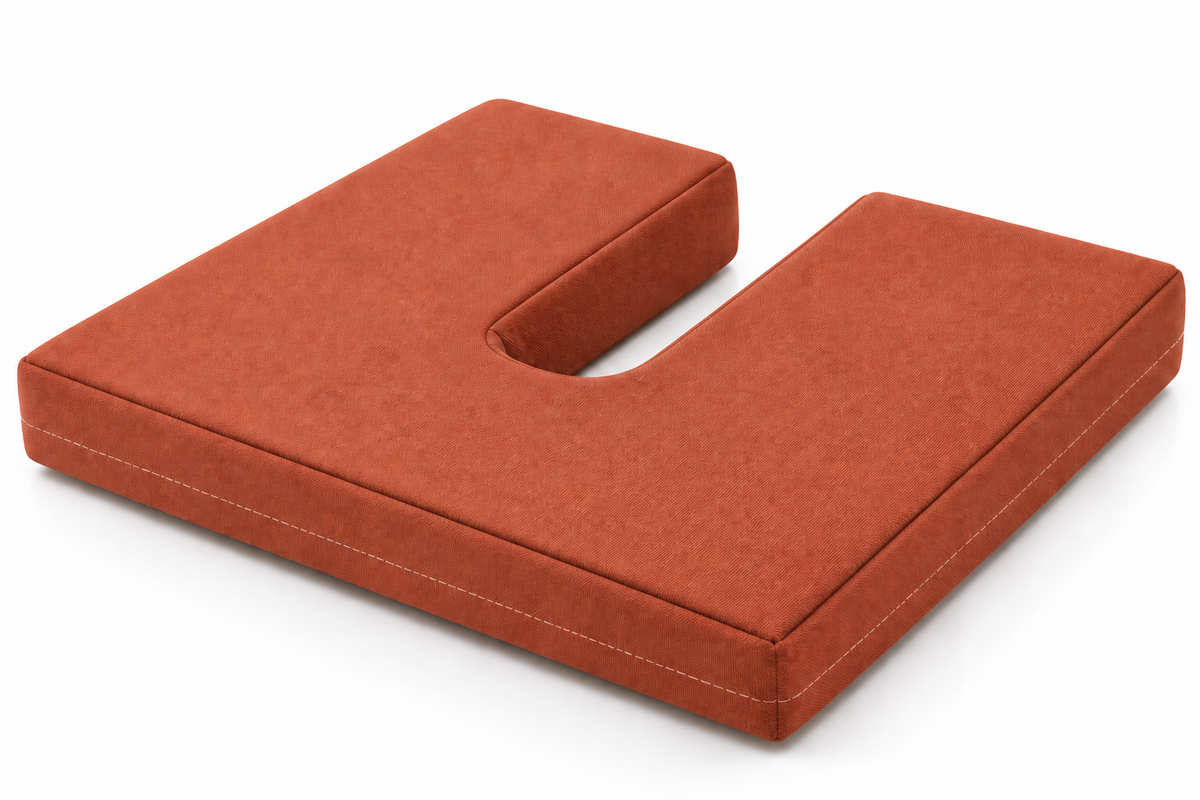 An ergonomic U-shaped contoured seat cushion in a terracotta rust color, shown on a clean white background.
