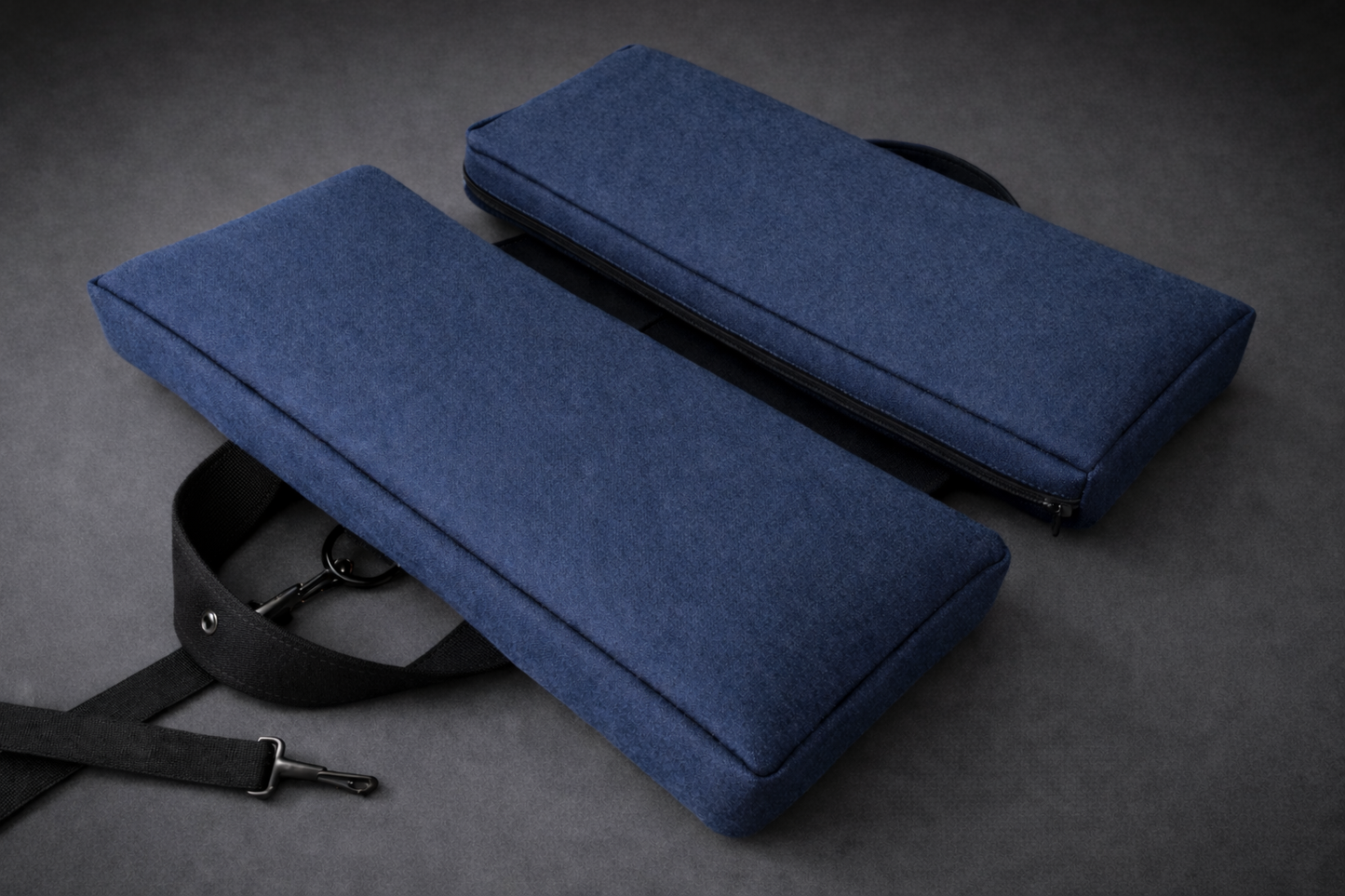 Cerulean blue SunCloud travel cushion with ergonomic support, black strap and zipper, designed to relieve tailbone pressure and support pelvic comfort during sitting