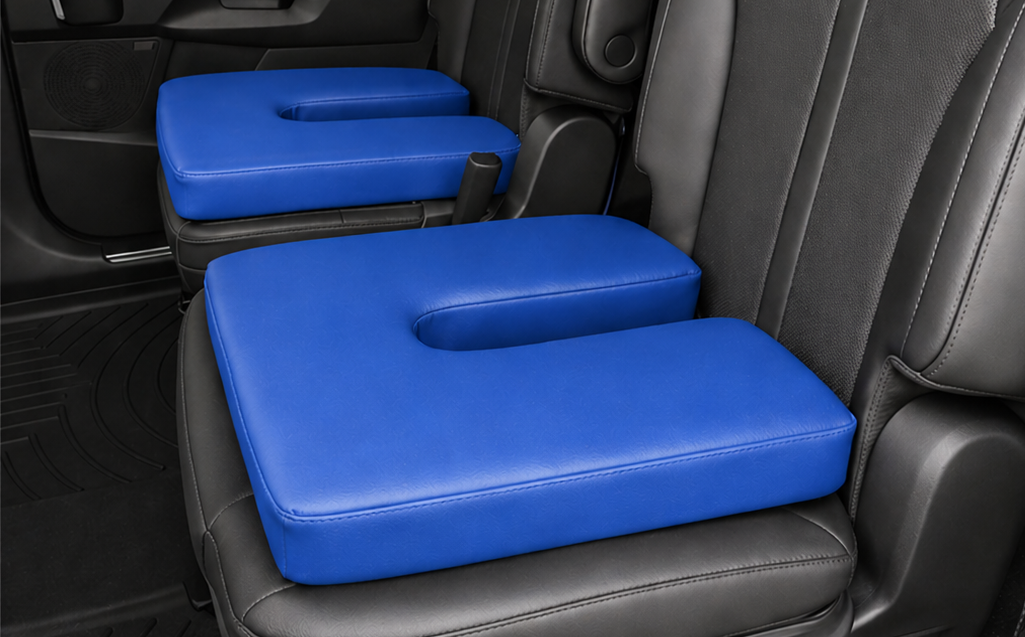 Royal blue U-shaped seat cushions on black leather car seats designed for tailbone and pelvic pain relief with ergonomic center cutout for pressure reduction