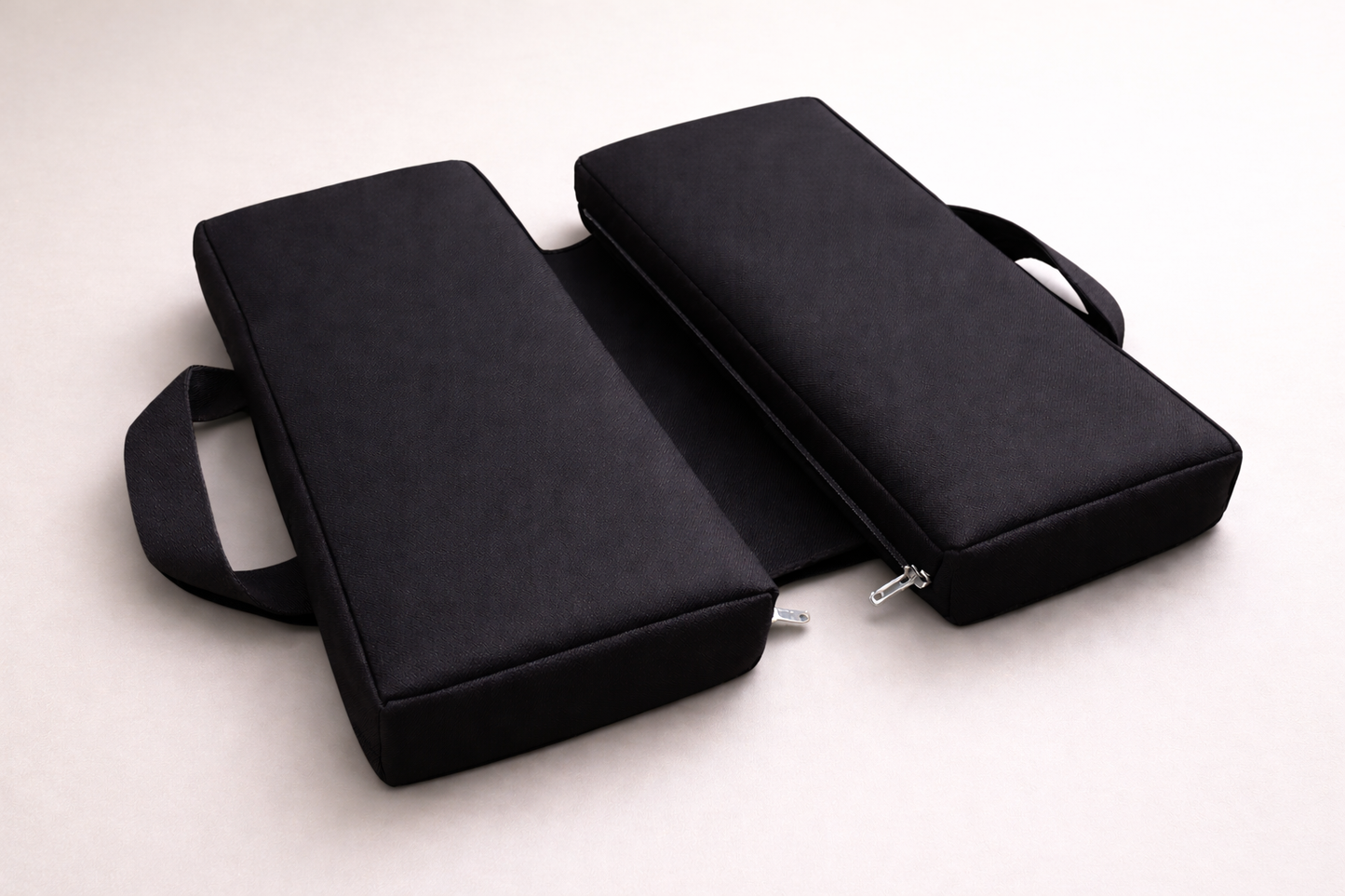 SunCloud® black canvas water repellent travel seat cushion with foldable design, providing ergonomic pelvic and tailbone support for sitting, driving, and long travel