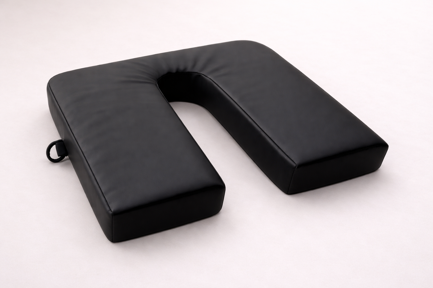 SunCloud® black canvas water-repellent U-shape coccyx seat cushion designed for tailbone relief and ergonomic pelvic support for sitting, driving, and everyday use